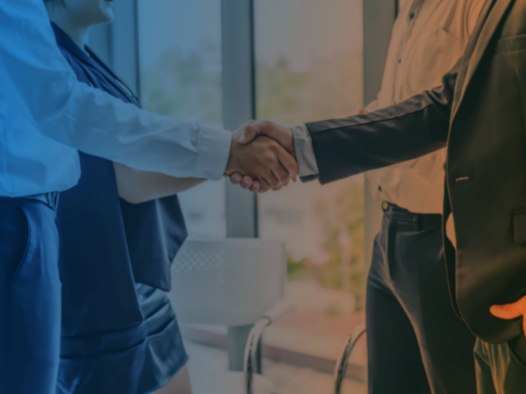 Two people shaking hands in a business meeting